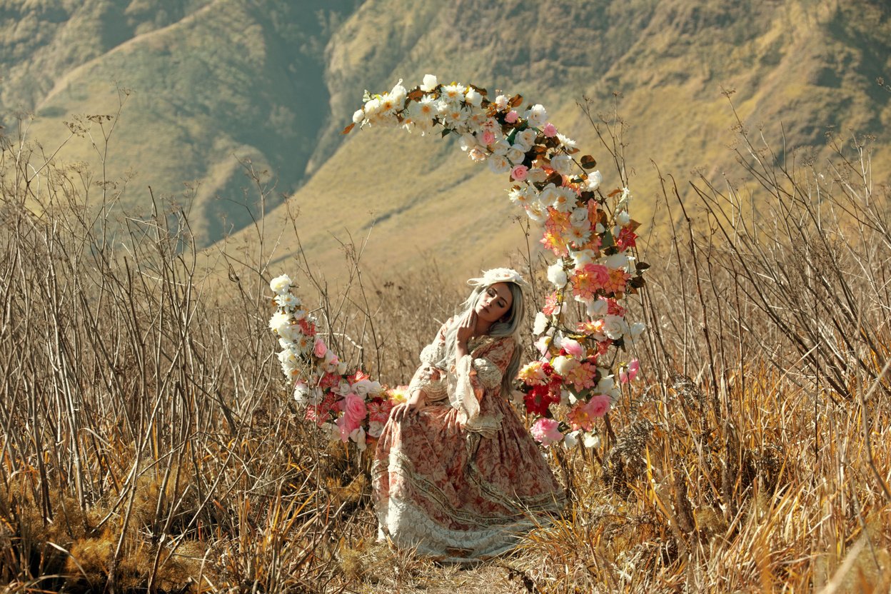 Woman Sitting on Crescent Moon Floral Chair